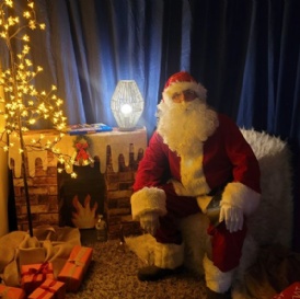 Santa Claus sat in his School Grotto